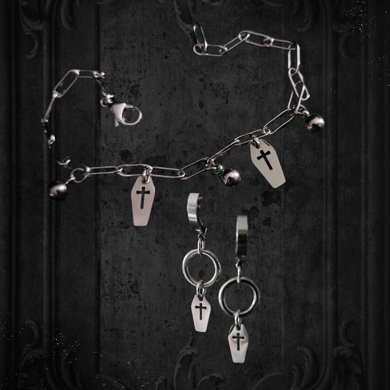 Gothic-style jewelry set with necklaces and earrings on a dark background