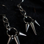 Load image into Gallery viewer, Pair of silver earrings dangling with short and long spikes hanging from chain links.
