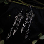 Load image into Gallery viewer, Pair of silver earrings with chained spikes dangling from floral checkered pendant.
